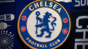Chelsea Football Club crest: blue circle with a gold border, a blue lion holding a staff, surrounded by red roses and text.