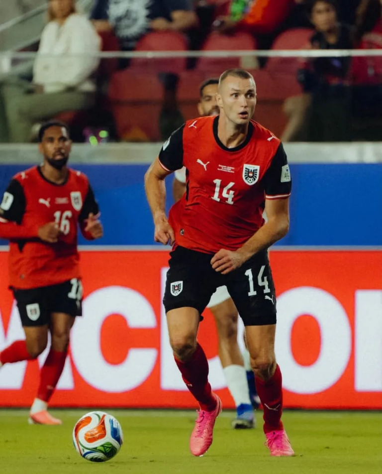 Soccer player in a red jersey #14 dribbles the ball on a green field during a match, with teammates and fans in the background.] , not good