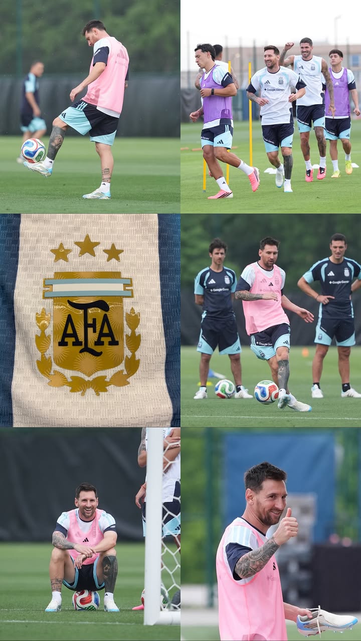 Soccer player in a pink bib kicks a ball on a green training field at practice.