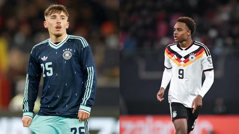 Two soccer players on a stadium pitch: left player in a dark blue Germany kit with number 25, right player in a white Germany kit with number 9 and a German flag stripe across the chest.