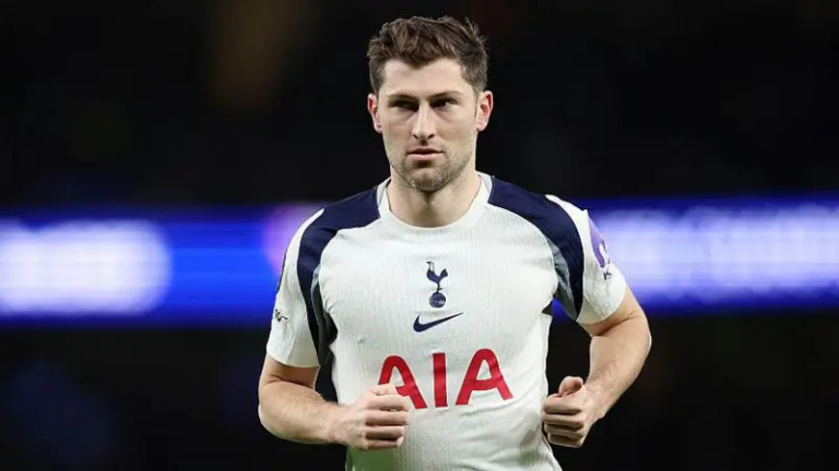 Professional male soccer player wearing a white Tottenham Hotspur jersey with AIA sponsor, running on the pitch.