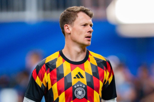 Male soccer player wearing a Germany national team jersey with a red, black, and yellow geometric pattern and crest visible on the chest.