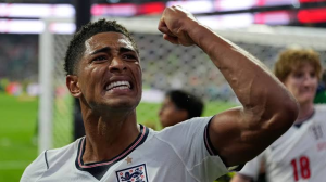 England soccer player celebrates with a raised fist on the field after a match.