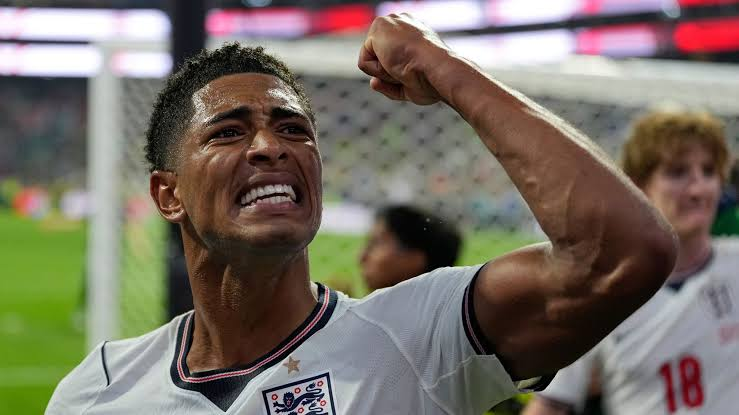 England soccer player celebrates with a raised fist on the field after a match.