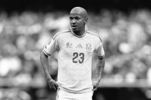 Male soccer player with jersey number 23 standing on the field, hands on hips (black-and-white photo).