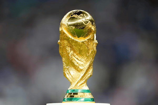 Golden FIFA World Cup trophy with a globe on top, mounted on a teal-and-gold base.
