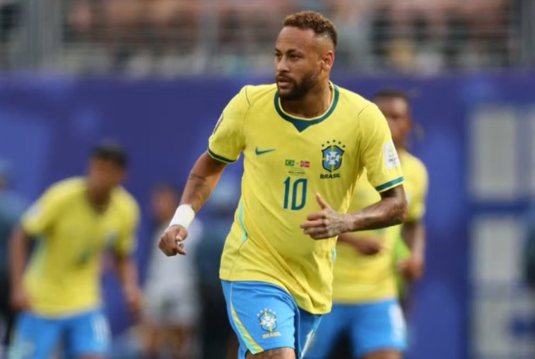 Brazil national team footballer wearing number 10 jersey in a yellow kit runs on the pitch during a match.
