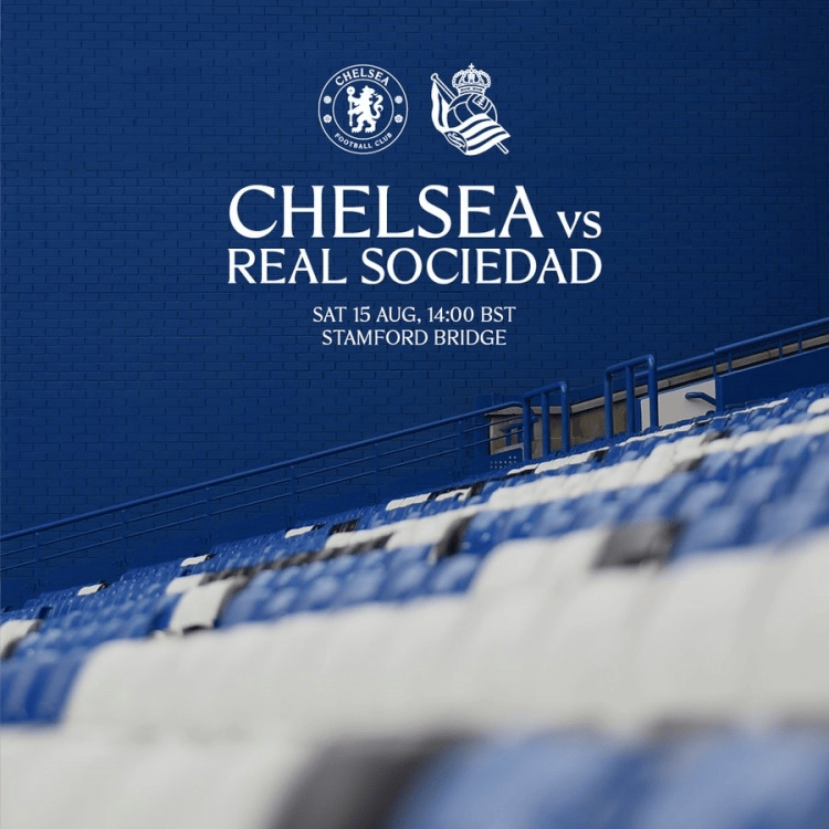 Banner for Chelsea vs Real Sociedad on a blue stadium wall with white text and logos, empty blue seats in foreground.