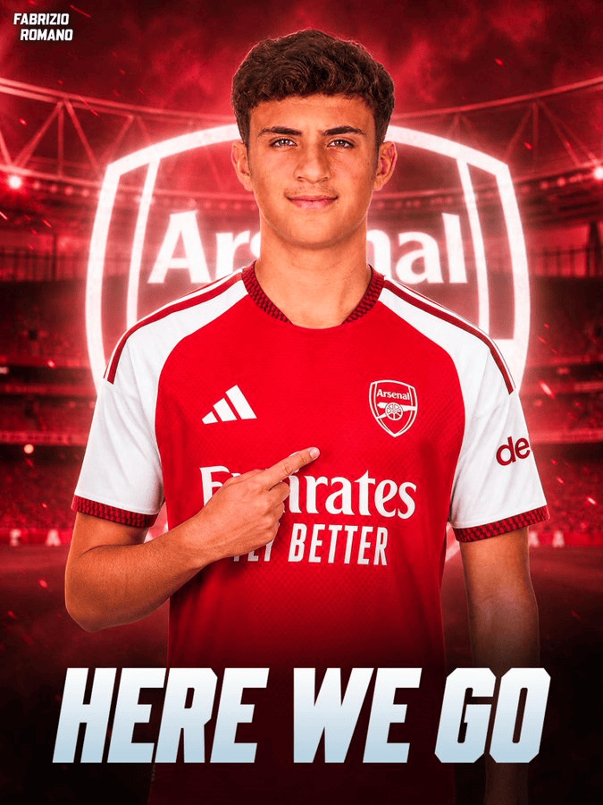 Young man in Arsenal red jersey points to his chest against a stadium backdrop with 'HERE WE GO' at the bottom.