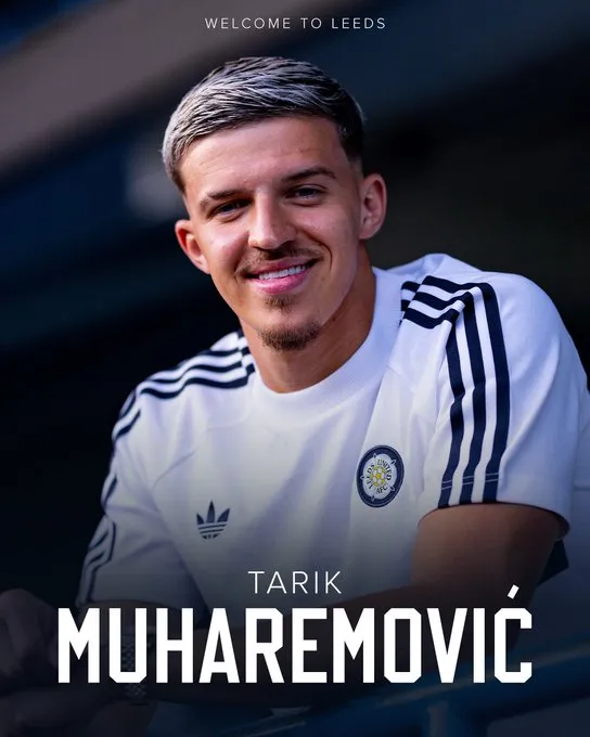 Portrait of Tarik Muharemović smiling in a white Leeds United training top with the club crest visible, 'Welcome to Leeds' above him.