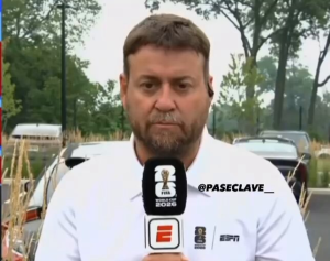 Male sports reporter outdoors speaking into a branded microphone with ESPN and World Cup logos visible in a park-like setting.