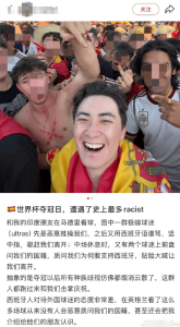 Smiling man in a Spanish flag taking a selfie amid a crowded, faces-blurred crowd at a sports event.