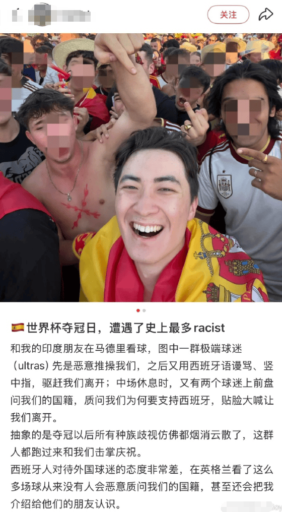 Smiling man in a Spanish flag taking a selfie amid a crowded, faces-blurred crowd at a sports event.