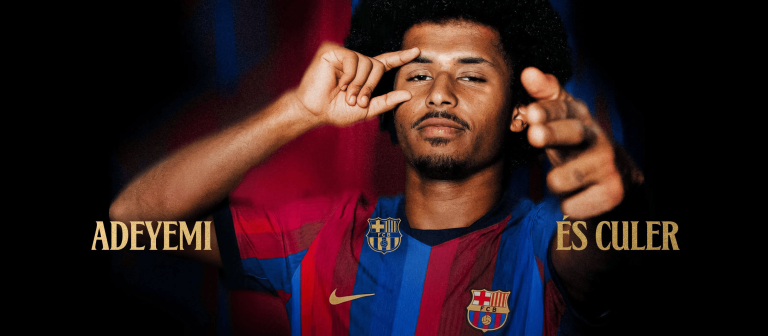 Portrait of Adeyemi in a FC Barcelona jersey, gesturing toward the viewer with fingers; gold 'ADEYEMI ÉS CULER' text at the sides.