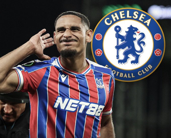 Soccer player in red-blue striped jersey saluting with Chelsea FC emblem in the background, sponsor NET88 on shirt nearby