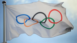 White flag with interlocked Olympic rings: blue, orange, black, green, and red on a white background