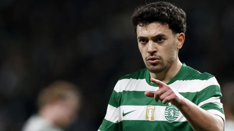 Male soccer player in a green-and-white striped Sporting CP jersey points forward during a match.